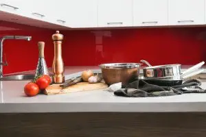 Red Kitchen with tomatos and saucpan in foreground